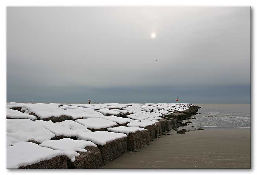 Snow on the rock groins at the beach in Galveston.