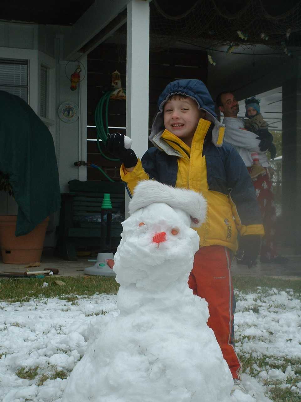 Robby & Kathy Franks son Jack stand by his snowman.