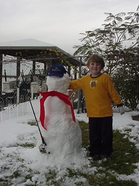 Cole with neighbor Judy's snowman.