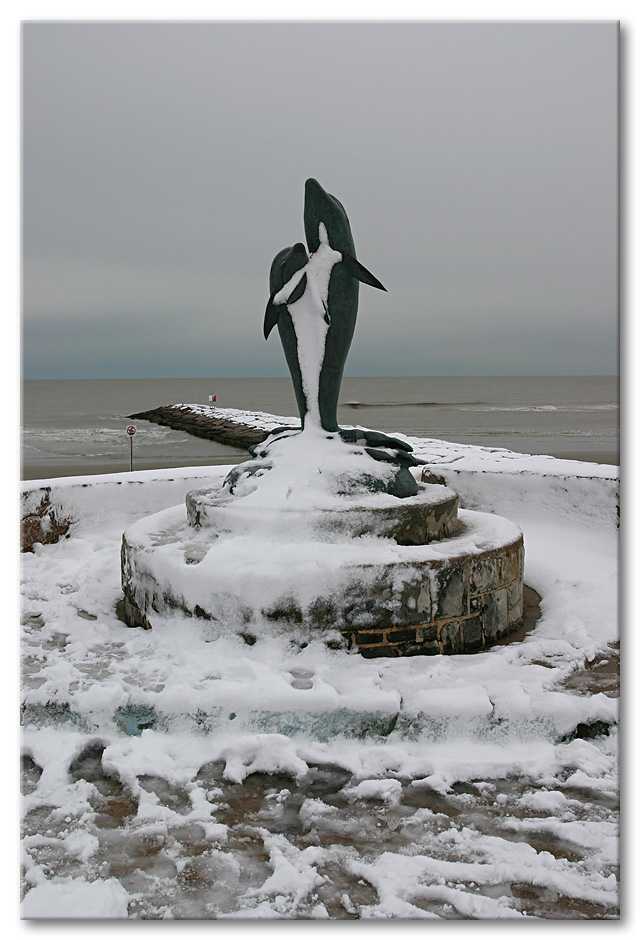 Dolphin sculpture on the seawall, in Galveston.