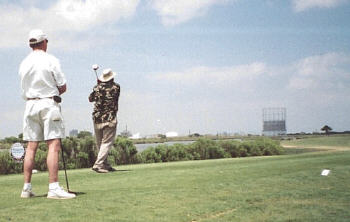 John watches as Joe takes a swing.